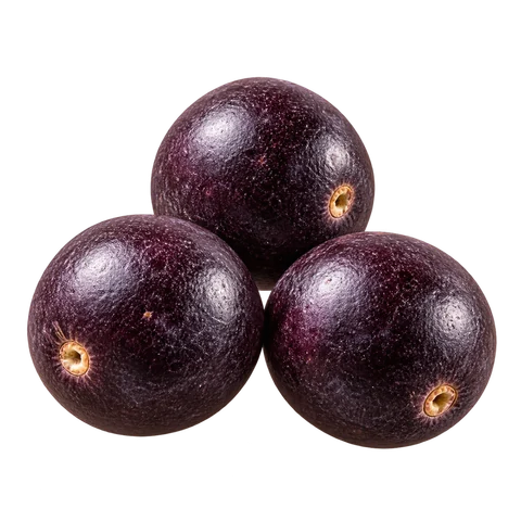 A close-up of three whole açaí berries