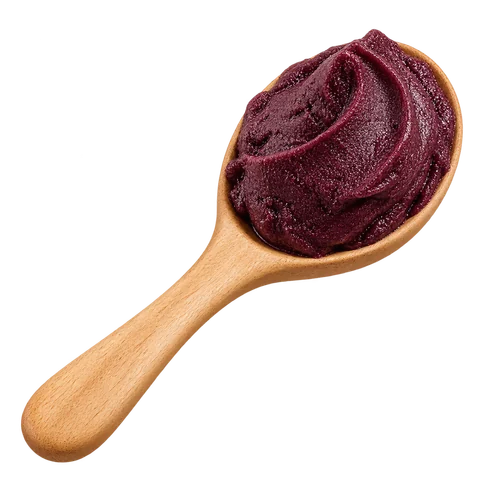 A wooden spoon filled with deep-purple açaí pulp
