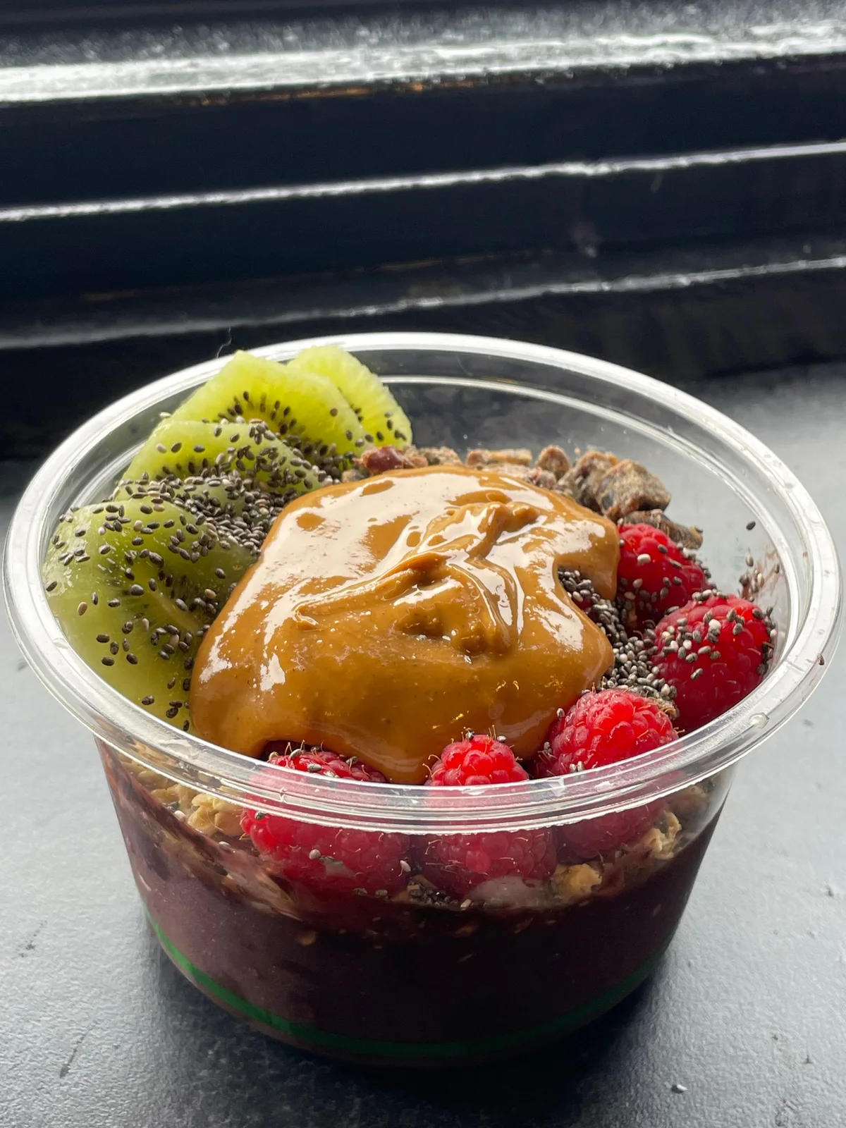 A thick purple açaí base topped with raspberries, kiwi, chia and peanut butter