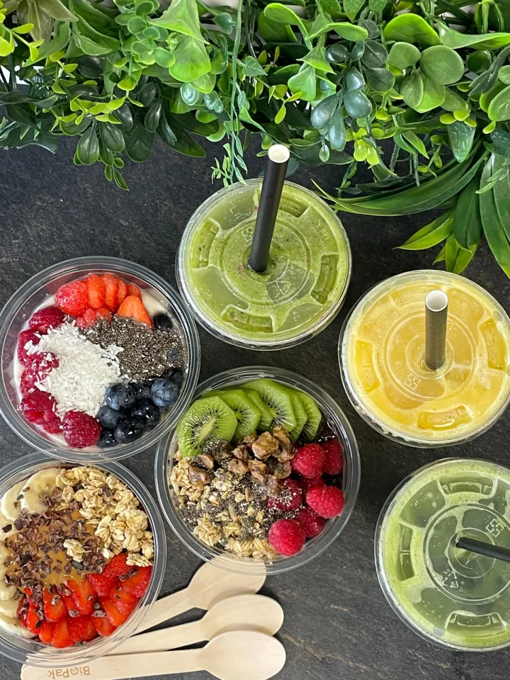 Fruit-topped açaí and yoghurt bowls alongside iced drinks